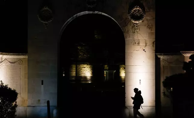 A pedestrian walks along Brown University's campus on Thayer St. in Providence, R.I., Wednesday, Dec. 17, 2025. (Lily Speredelozzi/The Sun Chronicle via AP)