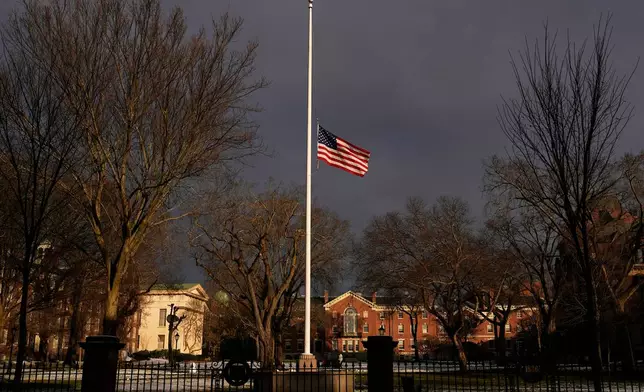 The U.S. flag flies at half-staff on the Main Green in honor of the victims of the campus shooting at Brown University, Wednesday, Dec. 17, 2025, in Providence, R.I. (AP Photo/Robert F. Bukaty)