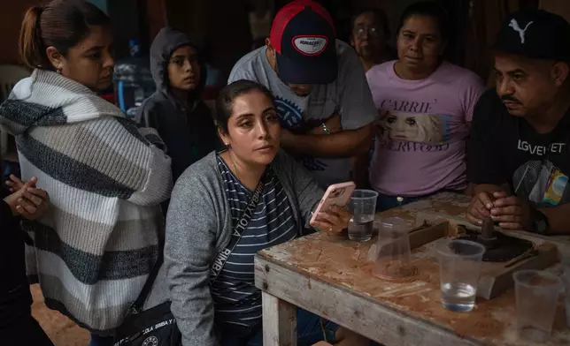 Relatives of Lt. Luis Enrique Castillo, a victim of a Mexican Navy plane crash off the Texas coast, learn about his death, at the family house in El Pantano, Veracruz state, Mexico, Tuesday, Dec. 23, 2025. (AP Photo/Felix Marquez)