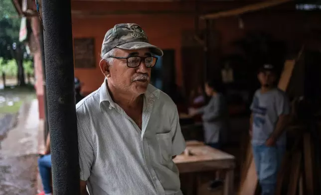 Eduardo Castillo, the father of Lt. Luis Enrique Castillo, a victim of a Mexican Navy plane crash off the Texas coast, gathers with family at their home in El Pantano, Veracruz state, Mexico, Tuesday, Dec. 23, 2025. (AP Photo/Felix Marquez)