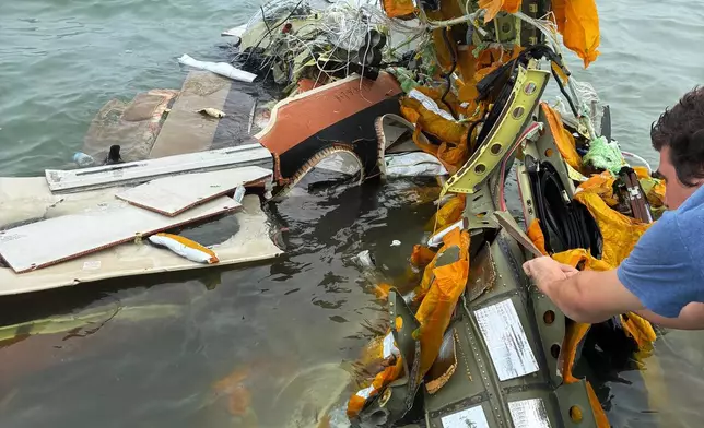 In this image provided by Sky Decker Jr., authorities and volunteers respond to a Mexican Navy plane crash near Galveston, Texas, Monday, Dec. 22, 2025. (Sky Decker Jr. via AP)