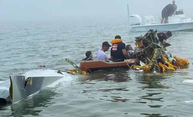 In this image provided by Sky Decker Jr., authorities and volunteers respond to a Mexican Navy plane crash near Galveston, Texas, Monday, Dec. 22, 2025. (Sky Decker Jr. via AP)null