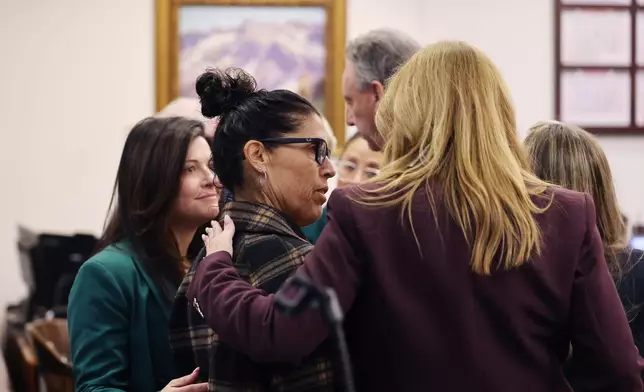 Tyler Skaggs mother, Debbie Skaggs, center, gets a hug in court after a settlement was reached in the wrongful death lawsuit by the family of pitcher Tyler Skaggs against the Los Angeles Angels in Orange County Superior Court in Santa Ana, Calif., Friday, Dec. 19, 2025. (Allen J. Schaben/Los Angeles Times via AP, Pool)