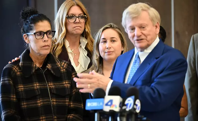 Attorney Russell Hardin Jr. right speaks in front of Tyler Skaggs' widow Carli Skaggs, center, and mother Debbie Skaggs, at left, after a settlement was reached in the wrongful death lawsuit by the family of the Los Angeles Angels pitcher Friday, Dec. 19, 2025, in Orange County Superior Court, in Santa Ana, Calif. (AP Photo/William Liang)