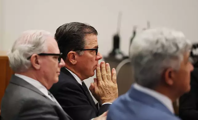 John Carpino, center, president of the Los Angeles Angels, sits with Kevin Dorse, left, and Todd Theodora as they wait for a verdict in the wrongful death lawsuit by the family of pitcher Tyler Skaggs against the Los Angeles Angels in Orange County Superior Court in Santa Ana, Calif., Friday, Dec. 19, 2025. (Allen J. Schaben/Los Angeles Times via AP, Pool)