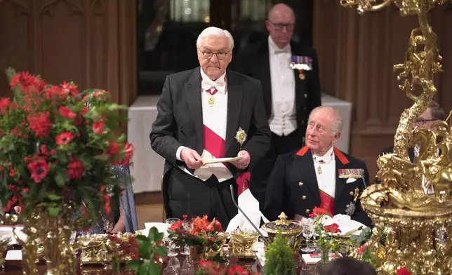 German President Frank-Walter Steinmeier, left, delivers a speech next to King Charles III, right, during the state banquet for the German President and his wife, at Windsor Castle, Berkshire, England, Wednesday, Dec. 3, 2025. (Yui Mok/PA via AP, Pool)