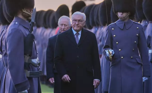 German President Frank-Walter Steinmeier inspects the Guard of Honour with Britain's King Charles III during the ceremonial welcome at the start of his State Visit to the United Kingdom, at Windsor Castle in Windsor, England, Wednesday, Dec. 3, 2025. (AP Photo/Kin Cheung, Pool)