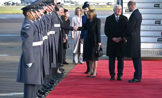 Britain's Prince William, right, speaks with Germany's President Frank-Walter Steinmeier, as Britain's Catherine, Princess of Wales, introduces dignitaries to his wife Elke Büdenbender, at Heathrow Airport in London, Wednesday, Dec. 3, 2025 (Jeff Spicer/Pool Photo via AP)