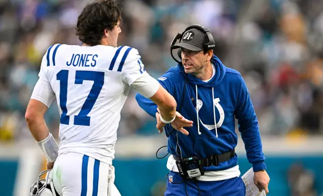 Indianapolis Colts head coach Shane Steichen celebrates a touchdown with quarterback Daniel Jones (17) during the first half of an NFL football game against the Jacksonville Jaguars, Sunday, Dec. 7, 2025, in Jacksonville, Fla. (AP Photo/Phelan M. Ebenhack)