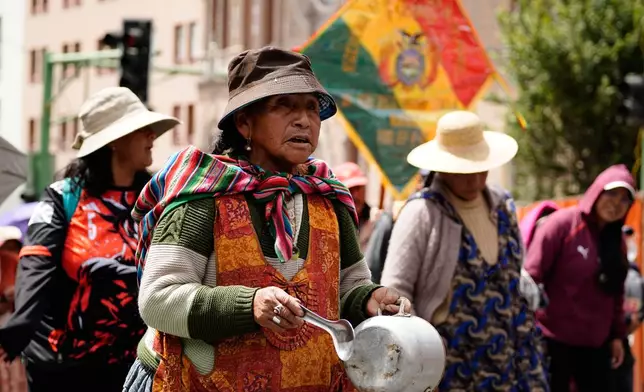 People protest President Rodrigo Paz's announcement to stop subsidizing fuel in La Paz, Bolivia, Friday, Dec. 19, 2025. (AP Photo/Freddy Barragan)