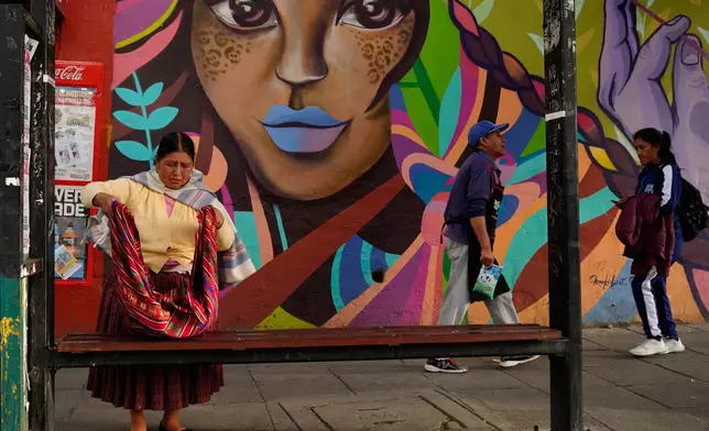 People walk during strike by the public transportation sector in La Paz, Bolivia, Friday, Dec. 19, 2025, after President Rodrigo Paz announced the end of fuel subsidies. (AP Photo/Freddy Barragan)