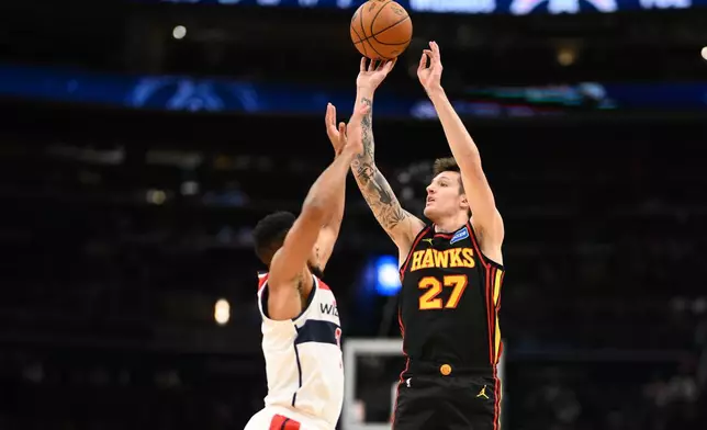 Atlanta Hawks guard Vit Krejci (27) shoots against Washington Wizards guard CJ McCollum, left, during the second half of an NBA basketball game, Saturday, Dec. 6, 2025, in Washington. (AP Photo/Nick Wass)
