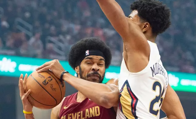 Cleveland Cavaliers' Jarrett Allen (31) drives to the basket as New Orleans Pelicans' Trey Murphy III (25) defends during the first half of an NBA basketball game in Cleveland, Tuesday, Dec. 23, 2025. (AP Photo/Phil Long)