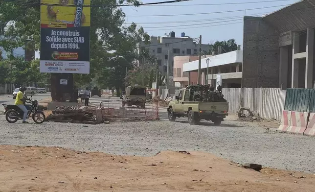 Soldiers ride in a military vehicle along a street amid an attempted coup in Cotonou Benin, Sunday Dec. 6, 2025. (AP Photo)