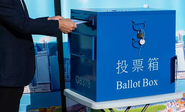 Hong Kong's Chief Executive John Lee casts his ballot at a polling station during the Legislative Council General Election in Hong Kong on Sunday, Dec. 7, 2025. (AP Photo/Chan Long Hei)