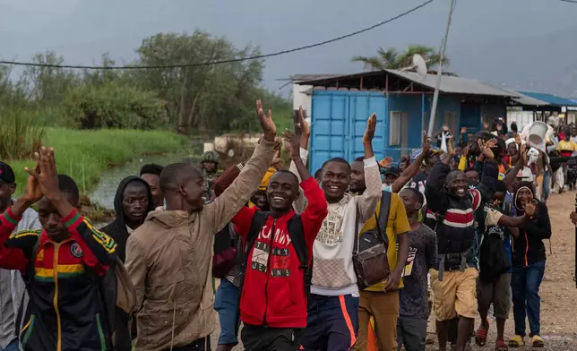 Burundian citizens who work in Uvira, Democratic Republic of the Congo, and could not cross back into their home country due to fighting, cross the border into Burundi, Sunday, Dec. 14, 2025. (AP Photo/Moses Sawasawa)