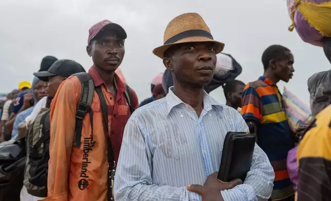 Burundian citizens who work in Uvira, Democratic Republic of the Congo, and could not cross back into their home country due to fighting, cross the border into Burundi, Sunday, Dec. 14, 2025. (AP Photo/Moses Sawasawa)