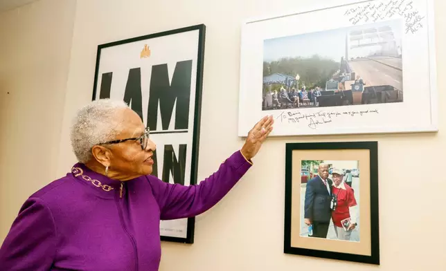 Dorris Crenshaw points to a photo of the Edmund Pettus Bridge as she prepares for the 70th anniversary of Rosa Park's Bus Boycott, Monday, Nov. 24, 2025, in Montgomery, Ala. (AP Photo/Butch Dill)