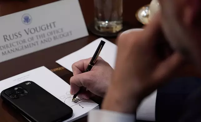 Russ Vought, Director of the Office of Management and Budget, attends the Cabinet meeting at the White House, Tuesday, Dec. 2, 2025, in Washington. (AP Photo/Julia Demaree Nikhinson)