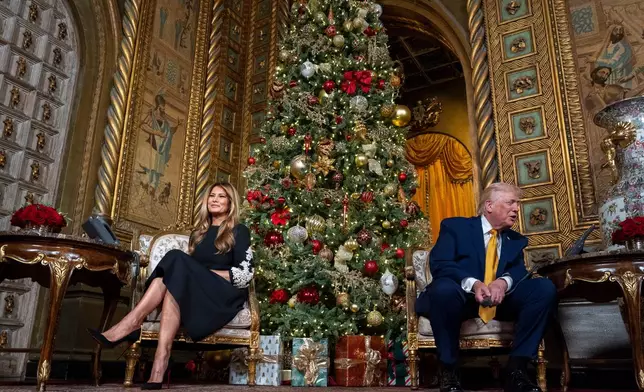 President Donald Trump, speaks accompanied by first lady Melania Trump, during a NORAD, North American Aerospace Defense Command, Tracks Santa Operation call at his Mar-a-Lago club, Wednesday, Dec. 24, 2025, in Palm Beach, Fla. (AP Photo/Alex Brandon)