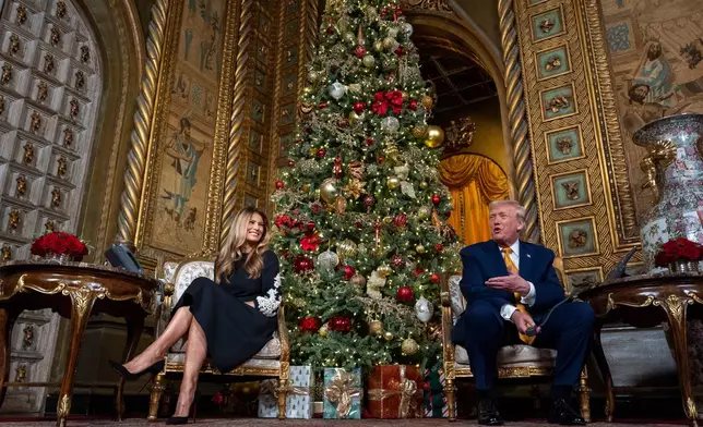 President Donald Trump, speaks accompanied by first lady Melania Trump, during a NORAD, North American Aerospace Defense Command, Tracks Santa Operation call at his Mar-a-Lago club, Wednesday, Dec. 24, 2025, in Palm Beach, Fla. (AP Photo/Alex Brandon)