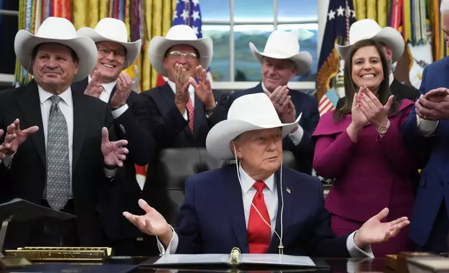 President Donald Trump attends a bill signing ceremony with members of the 1980 U.S. Men's Olympic Hockey team, Friday, Dec. 12, 2025, in the Oval Office of the White House, in Washington. (AP Photo/Jacquelyn Martin)