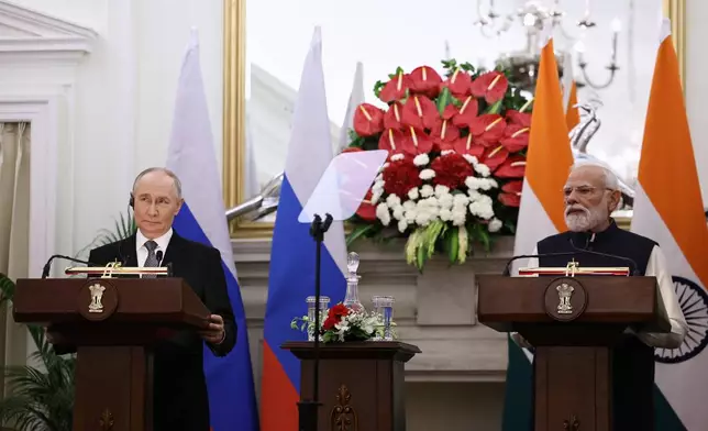 Russian President Vladimir Putin, left, and Indian Prime Minister Narendra Modi make a press statement after their talks at the Hyderabad House in New Delhi, India, Friday, Dec. 5, 2025. (Alexander Kazakov, Sputnik, Kremlin Pool Photo via AP)