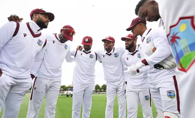 West Indies captain Roston Chase, center, talks to his players ahead of play against New Zealand during their cricket test match in Christchurch, New Zealand, Tuesday, Dec. 2, 2025. (Andrew Cornaga/Photosport via AP)