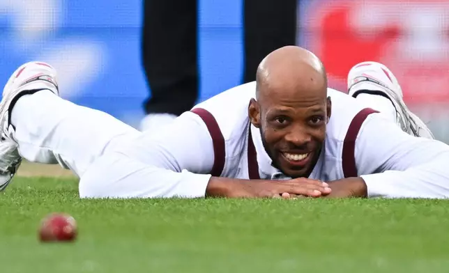 West Indies' Roston Chase lays on the ground after attempting to field against New Zealand during their cricket test match in Christchurch, New Zealand, Tuesday, Dec. 2, 2025. (Andrew Cornaga/Photosport via AP)
