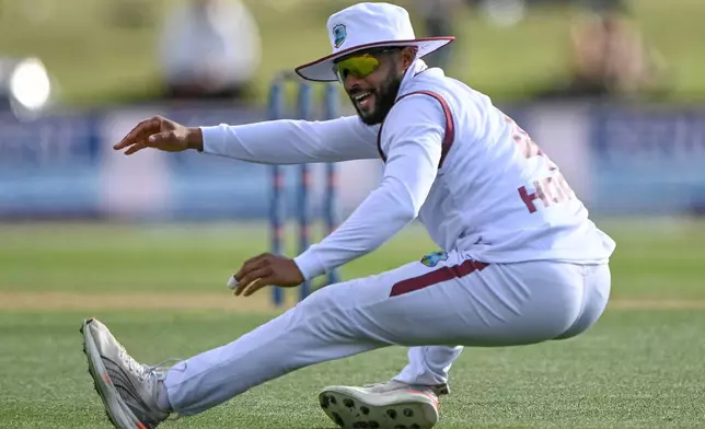 West Indies' Shai Hope falls after attempting to field against New Zealand during their cricket test match in Christchurch, New Zealand, Tuesday, Dec. 2, 2025. (Andrew Cornaga/Photosport via AP)