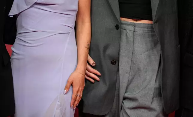 A film crew poses for a photo on the red carpet during the 22nd Marrakech Film Festival, in Morocco, Tuesday, Dec. 2, 2025. (AP Photo/Mosa'ab Elshamy)