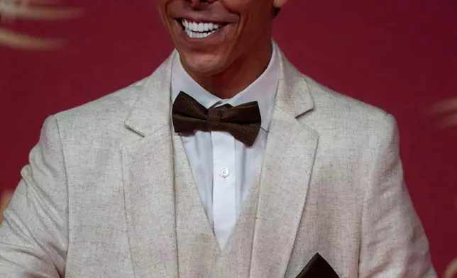 An actor poses for a photo on the red carpet during the 22nd Marrakech Film Festival, in Morocco, Tuesday, Dec. 2, 2025. (AP Photo/Mosa'ab Elshamy)
