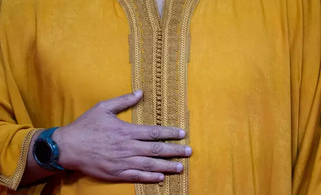 A Moroccan actor wearing a traditional outfit poses for a photo on the red carpet during the 22nd Marrakech Film Festival, in Morocco, Tuesday, Dec. 2, 2025. (AP Photo/Mosa'ab Elshamy)