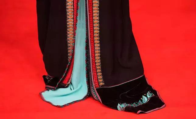 An actress poses for a photo on the red carpet during the 22nd Marrakech Film Festival, in Morocco, Tuesday, Dec. 2, 2025. (AP Photo/Mosa'ab Elshamy)