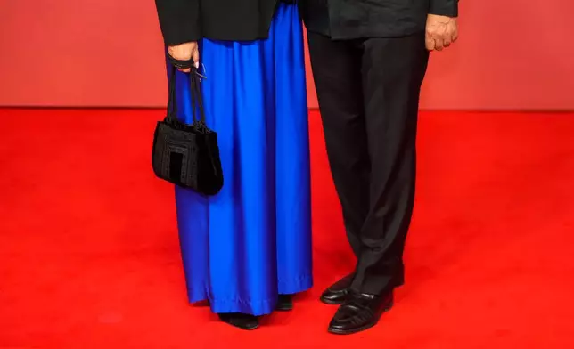 A couple poses for a photo on the red carpet during the opening ceremony of the 22nd Marrakech Film Festival, in Morocco, Friday, Nov. 28, 2025. (AP Photo/Mosa'ab Elshamy)