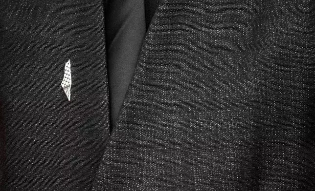 Filipino-Australian filmmaker James J. Robinson wears a pro-Palestinian pin representing the pre-1948 map while posing for a photo on the red carpet during 22nd Marrakech Film Festival, in Morocco, Tuesday, Dec. 2, 2025. (AP Photo/Mosa'ab Elshamy)