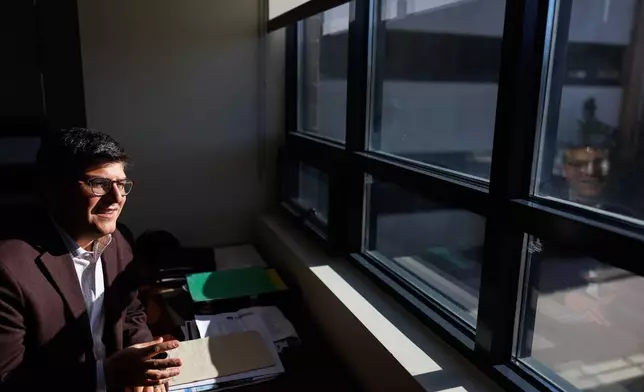 Juan Espinoza, vice provost for enrollment management at Virginia Tech, poses for a photo in his office, Nov. 12, 2025, in Blacksburg, Va. (AP Photo/Shaban Athuman)
