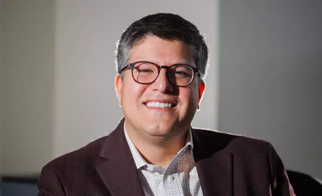 Juan Espinoza, vice provost for enrollment management at Virginia Tech, poses for a photo in his office, Nov. 12, 2025, in Blacksburg, Va. (AP Photo/Shaban Athuman)