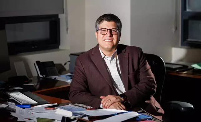 Juan Espinoza, vice provost for enrollment management at Virginia Tech, poses for a photo in his office, Nov. 12, 2025, in Blacksburg, Va. (AP Photo/Shaban Athuman)