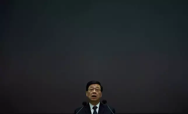 Hong Kong Chief Executive John Lee speaks during a press conference with a darken screen in the aftermath of a deadly fire in Hong Kong on Tuesday, Dec. 2, 2025. (AP Photo/Ng Han Guan)