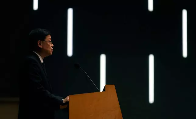 Hong Kong Chief Executive John Lee speaks during a press conference with a darken screen in the aftermath of a deadly fire in Hong Kong on Tuesday, Dec. 2, 2025. (AP Photo/Ng Han Guan)