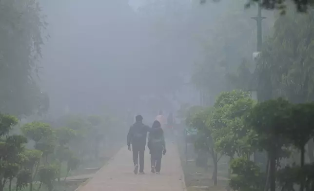 People walk through a public park in a dense smog-covered morning in New Delhi, India, Monday, Dec. 15, 2025. (AP Photo)