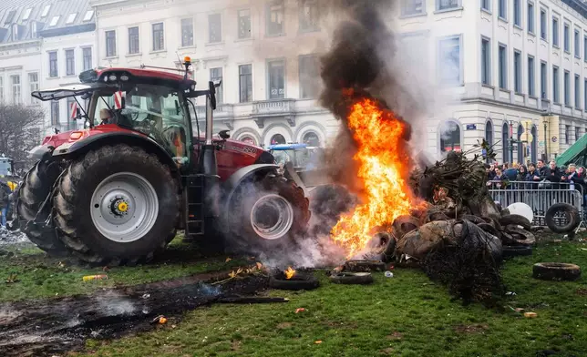 Protestors burn tires during a demonstration of European farmers outside the EU Summit meeting in Brussels, Thursday, Dec. 18, 2025. (AP Photo/Marius Burgelman)