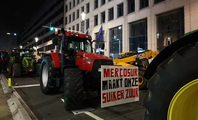 Farmers use their tractors to block a main road during a demonstration outside a gathering of European leaders at the EU Summit in Brussels, Thursday, Dec. 18, 2025. (AP Photo/Omar Havana)