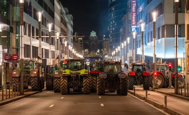 Farmers drive their tractors to block a main boulevard during a demonstration outside a gathering of European leaders at the EU Summit in Brussels, Thursday, Dec. 18, 2025. (AP Photo/Marius Burgelman)