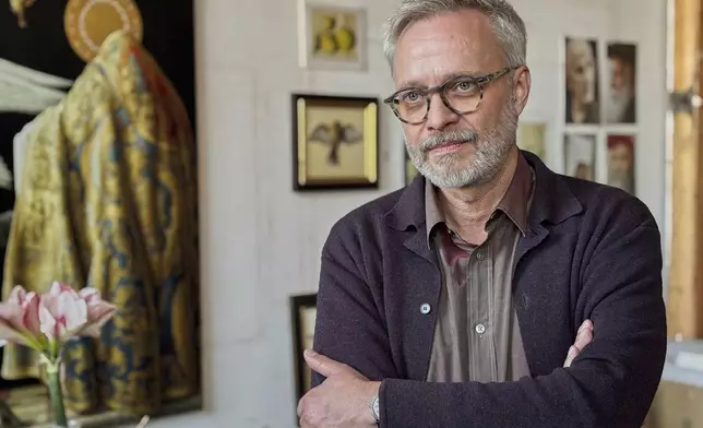 Painter Michael Triegel poses for photos during an interview with The Associated Press at his studio in Leipzig, Germany, Tuesday, Dec. 2, 2025. (AP Photo/Pietro De Cristofaro)