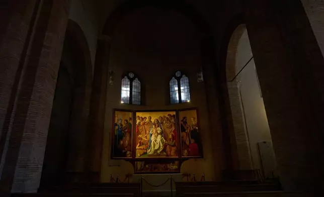 A painting, the central of the triptych, by German artist Michael Triegel who portrayed in 2018 as St. Peter Burkhard Scheffler, a homeless man who died from the cold in 2022, is displayed in the chapel of the Teutonic College at the Vatican, Wednesday, Dec. 10, 2025. (AP Photo/Alessandra Tarantino)