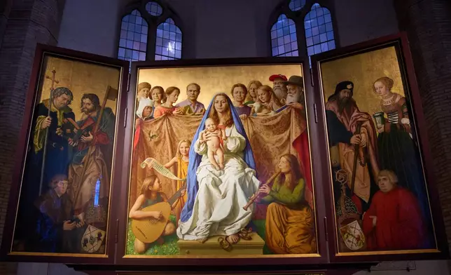 Burkhard Scheffler, second from right, a homeless man who died from the cold in 2022 on the edge of St. Peter's Square, is portrayed as St. Peter in a painting, the central of the triptych, by German artist Michael Triegel and exposed in the chapel of the Teutonic College at the Vatican, Wednesday, Dec. 10, 2025. (AP Photo/Alessandra Tarantino)