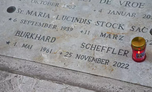A photo shows the tomb of Burkhard Scheffler, a homeless man who died from the cold in 2022 and portrayed in 2018 as St. Peter by German artist Michael Triegel, in the Teutonic cemetery at the Vatican, Wednesday, Dec. 10, 2025. (AP Photo/Alessandra Tarantino)
