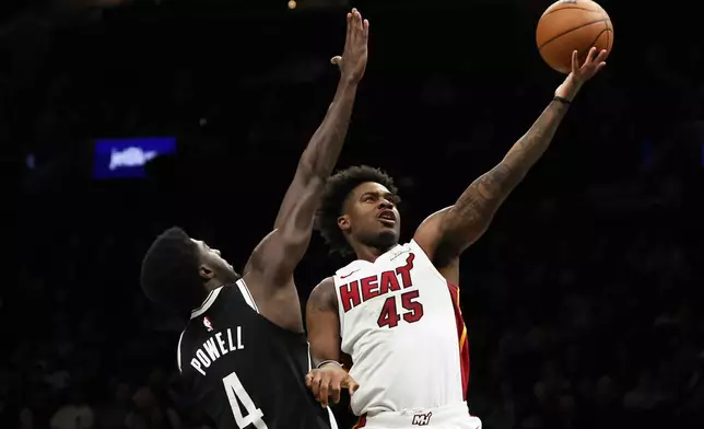 Miami Heat guard Davion Mitchell (45) goes up for a shot past Brooklyn Nets guard Drake Powell (4) during the first half of an NBA basketball game, Thursday, Dec. 18, 2025, in New York. (AP Photo/Heather Khalifa)